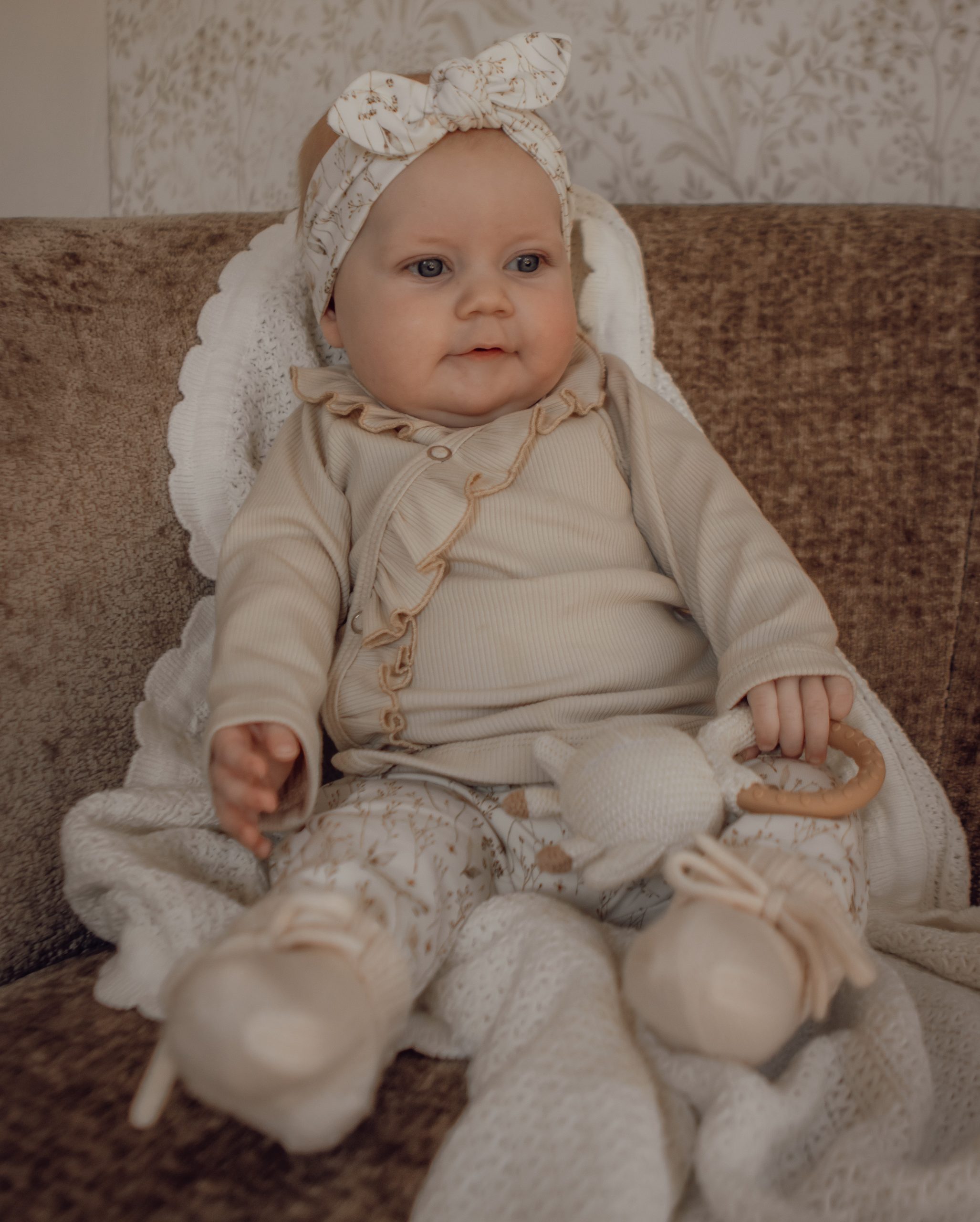 Newborn overslagshirtje met ruffles in een naturelkleur.
